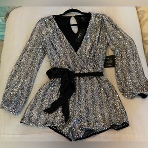 The Lulus More Than Magical Shiny Silver Sequin Long Sleeve Romper. Size: small